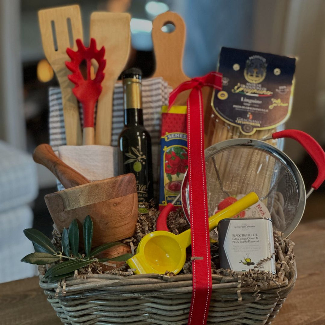 Blue ceramic dish with a ribbon being placed into a gift box.
